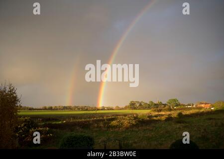 Double rainbow over fields. Hayling Island, Hampshire Stock Photo