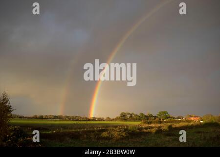 Double rainbow over fields. Hayling Island, Hampshire Stock Photo