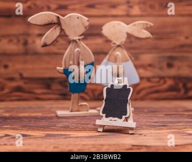 blank billboard in front of a wooden easter bunnies on old wood background Stock Photo