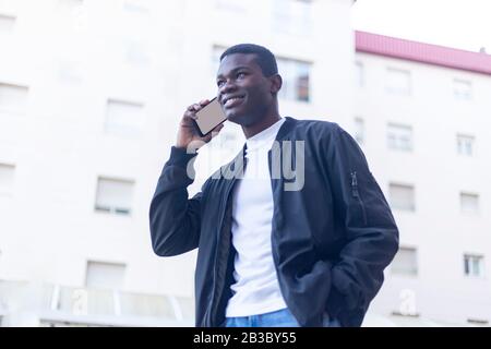 Afro man using mobile phone. Stock Photo