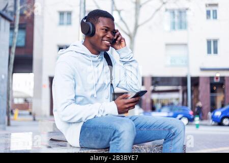 African Young Man Listening Music. Stock Photo