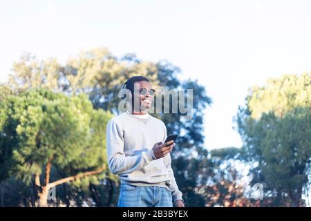Afro man using mobile phone. Stock Photo