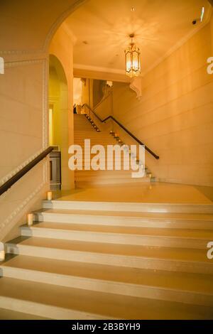 Luxury large white marble staircase, frontal view. Stock Photo