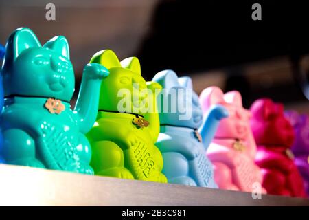Maneki-neko lucky fortune cat at the CookDaily stall in Market Hall West End, London, UK Stock Photo