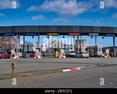 Cars approach the toll plaza at the Birkenhead side of the Queensway Tunnel to Liverpool under the River Mersey taken on a sunny day with a blue sky Stock Photo