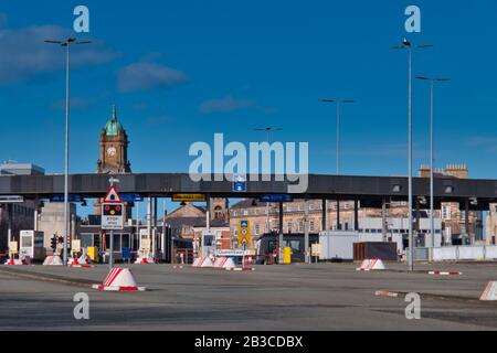 Cars approach the toll plaza at the Birkenhead side of the Queensway Tunnel to Liverpool under the River Mersey taken on a sunny day with a blue sky. Stock Photo