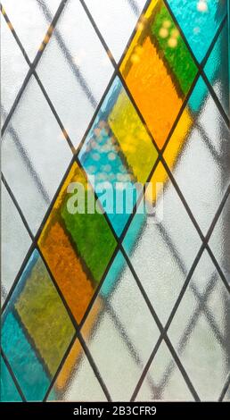 Stained glass. Colorful background of tiles with diagonally arranged parallelograms. Stock Photo