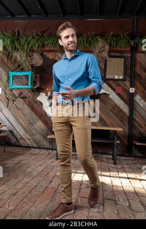 Confident casual man explaining and gesturing while wearing a blue