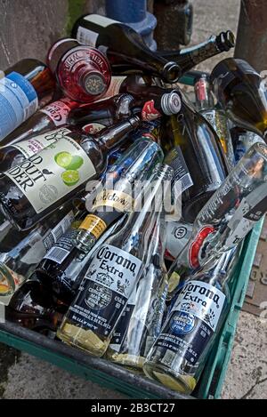 Empty bottles in a bin outside a public house waiting to be taken away to be recycled. Stock Photo
