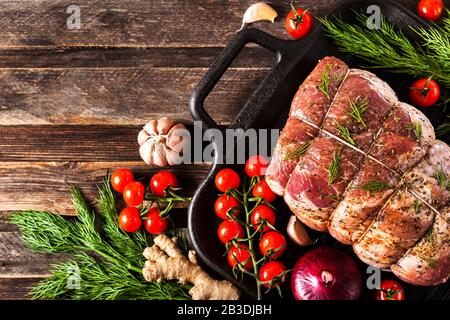 Raw pork meat with spices, ready to cook, on  dark background, top view with copy space Stock Photo