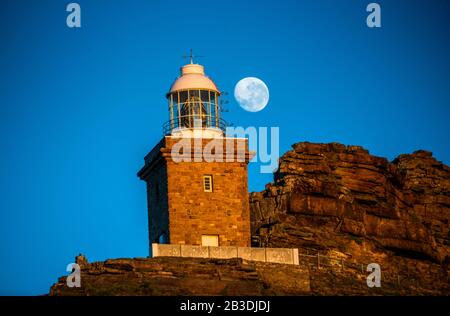 Lighthouse Cape of Good hope and moon in blue sky. South Africa. Stock Photo