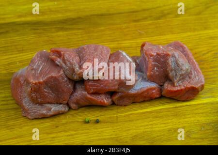 Sliced juicy pieces of veal stand on a wooden board Stock Photo