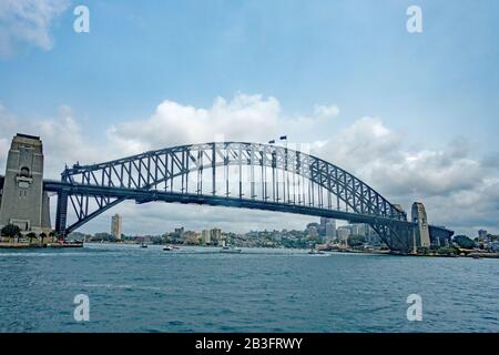 Sydney Harbour Bridge viewed from the water with people walking over the arch. Stock Photo