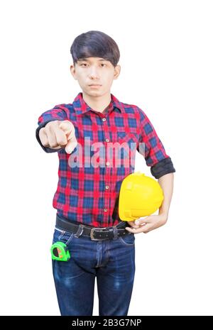Engineer finger point with holding safety yellow helmet plastic. looking camera on white background Stock Photo