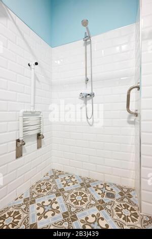 Moderm shower for disabled people in white and blue tone Stock Photo