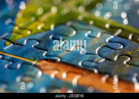 Selective focus on colorful pieces of a puzzle fitting together Stock Photo