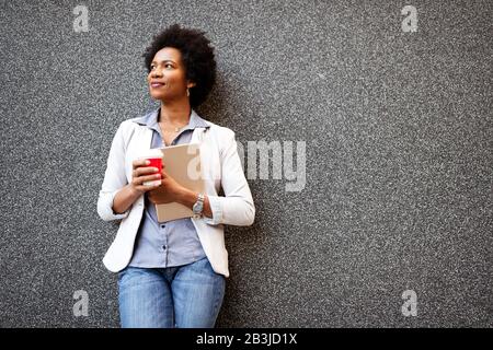 Urban happy business woman using tablet computer and working Stock Photo