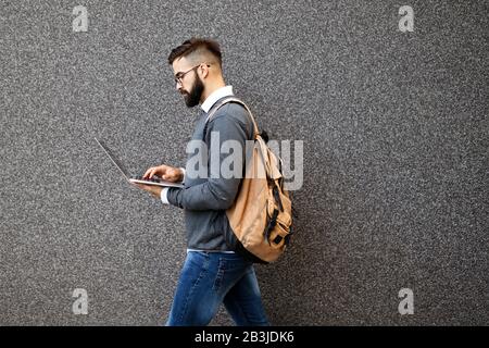 Handsome confident man using laptop computer outdoor Stock Photo