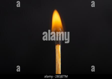 Burning match against a black background. Close-up shot Stock Photo