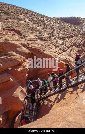 Tourists descending the stairs in Lower Antelope Canyon in Arizona Stock Photo