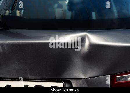 A dent in the body of a silver car Stock Photo