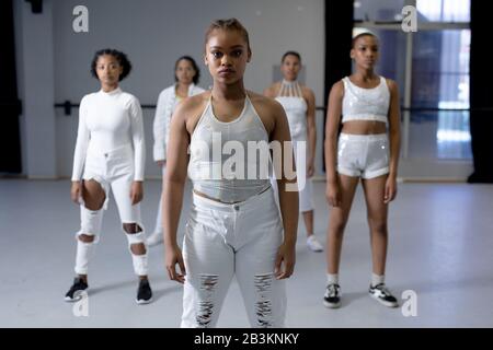 Mixed race modern dancers looking at camera in a studio Stock Photo