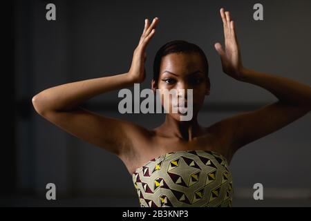 Mixed race female dancer wearing yellow dress Stock Photo