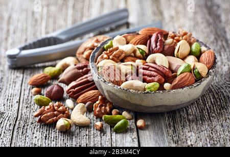 Mix nuts on a wooden background. Cut nuts Stock Photo