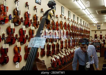 Violins on display in a musical instrument shop in Tokyo, Japan Stock Photo