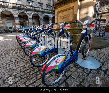 Launch of new electric bikes by Just Eat Cycles with bicycles in parking stand, City Chambers, Royal Mile, Edinburgh, Scotland, UK Stock Photo