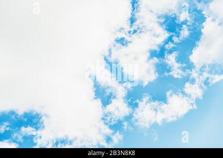 Light blue sky with big white clouds. Clouds floating on blue sky. Copy space Stock Photo