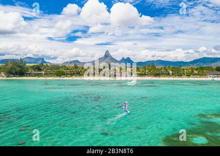 Aerial view by drone of windsurfer in the lagoon facing Flic en Flac beach and Piton de la Petite Riviere Noire mountain, Black River, Mauritius, Indi Stock Photo