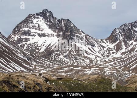 Fresh dusting of snow on the mountains surrounding Godthul, South Georgia, UK Overseas Protectorate, Polar Regions Stock Photo