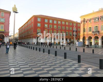 View of the famous department store Galeries Lafayette and the tram lines in the Place Massena, Nice, with pedestrians strolling outside. Stock Photo