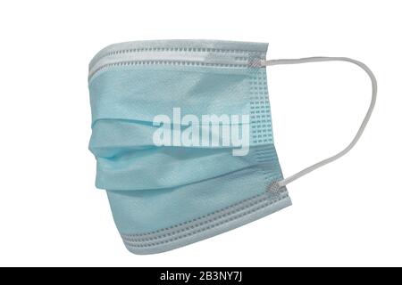Surgical mask with rubber ear straps. Typical 3-ply surgical mask to cover the mouth and nose. Procedure mask from bacteria. Protection concept. Stock Photo