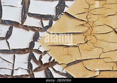 Abstract corroded old paint on metal wall. Cracked white beige yellow metal rust texture background Stock Photo
