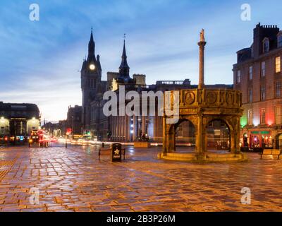 The Mercat Cross on Castle Street at dusk with the Town House in the distanceAberdeen Scotland Stock Photo