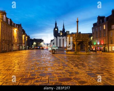 The Mercat Cross on Castle Street at dusk with the Town House in the distanceAberdeen Scotland Stock Photo