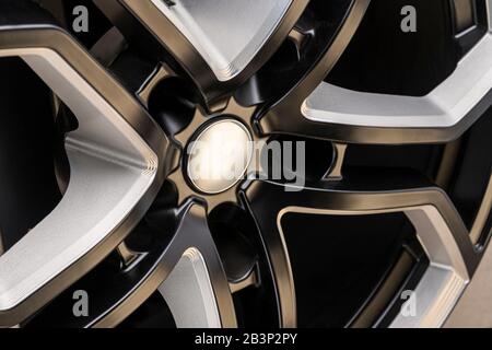 aluminum alloy wheel. Premium cast, the design of the spokes and the wheel rim, a white and black elements on dark background close-up. mockup. Stock Photo