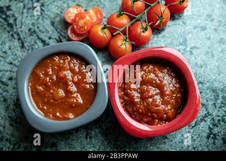 Spice up your salsa.Adding Tabasco Pepper sauce to tomato salsa.Hong Kong,China:05 Mar,2020.