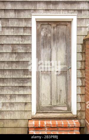 An old wooden door in a shingled home, East Hampton, NY Stock Photo