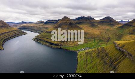 Aerial view of mountains and ocean around village of Funningur on Faroe Islands
