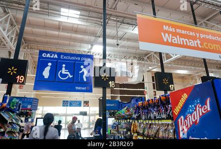 handicapped,pregnan cy, elderly preference sign at check out line, Walmart, Acapulco, Mexico Stock Photo