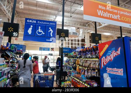 handicapped,pregnan cy, elderly preference sign at check out line, Walmart, Acapulco, Mexico Stock Photo