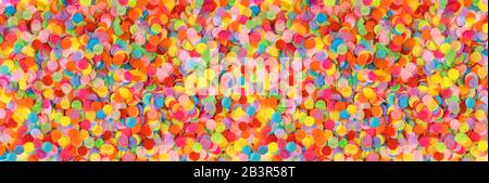 Banner made from bright multicolored confetti. Festive concept. Children's party, birthday, wedding, celebration. Top view. Copy space. Stock Photo