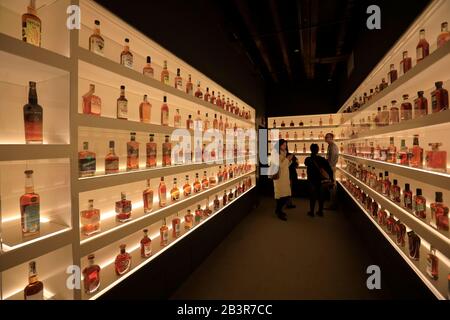 Visitors in the Bottle Hall it showcase every brand of bourbon currently produced in the state of Kentucky.Frazier History Museum. Louisville. Kentucky.USA Stock Photo