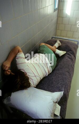 Austin, Texas USA, circa 1996: Female teen inmate (model) in juvenile detention center cell. ©Bob Daemmrich Stock Photo