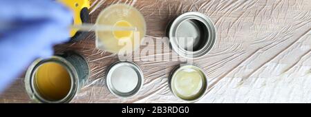 On wooden surface are cans varnish and stain Stock Photo
