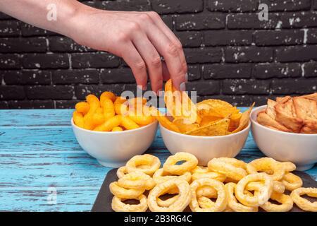 Differnt Types of Junk food, salty-sticks, salty-crackers on wooden table in still-life Stock Photo