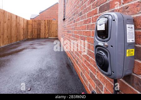 electric car charging point at a new build house in Manchester England Stock Photo